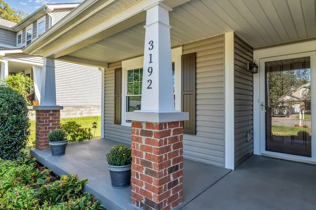a front view of a house with outdoor seating