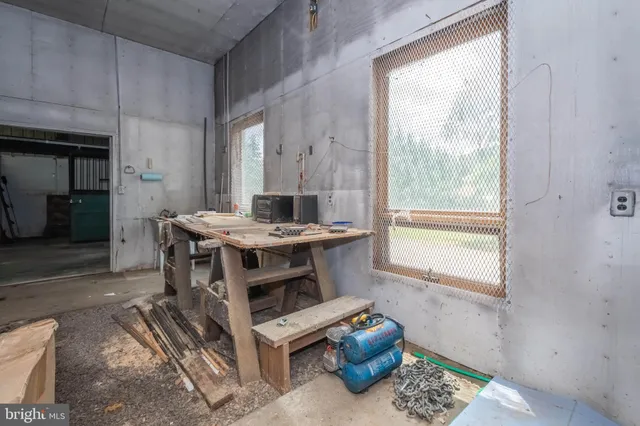 a view of a workspace with furniture and a window