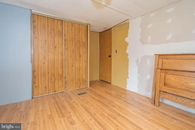 a view of an empty room with wooden floor
