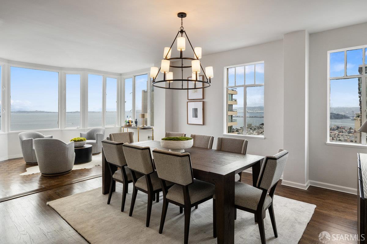 1101 Green Street, Unit 1801 San Francisco, CA 94109 - Photo 11 of 45 a dining room with furniture a chandelier and wooden floor