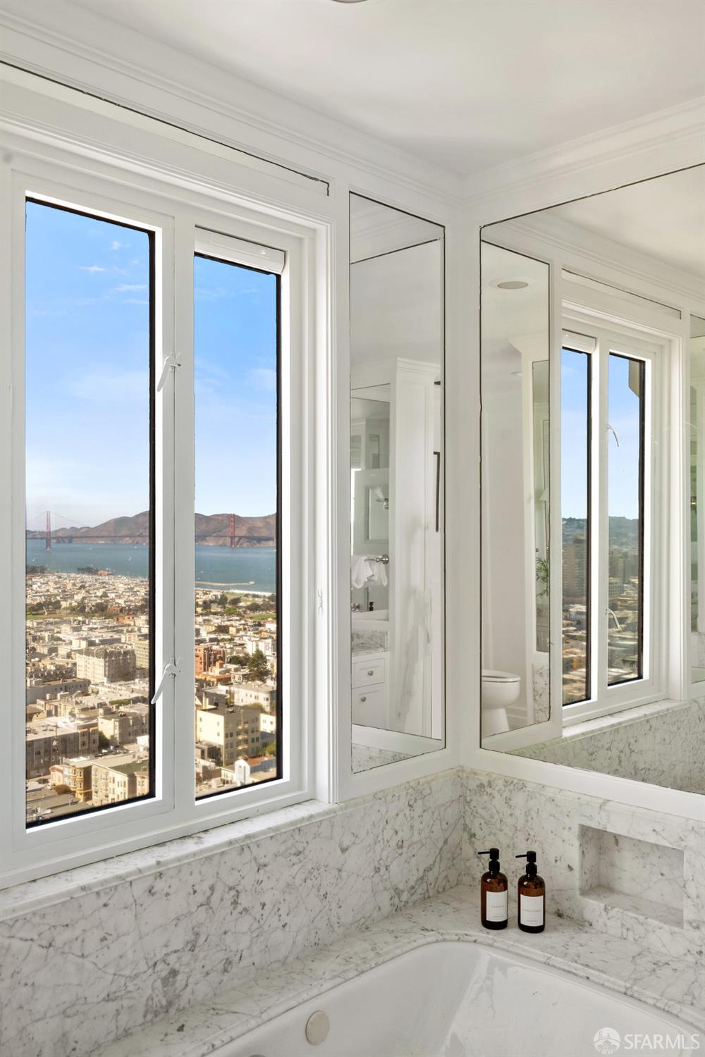 1101 Green Street, Unit 1801 San Francisco, CA 94109 - Photo 22 of 45 a bathroom with a tub that has a sink next to a window