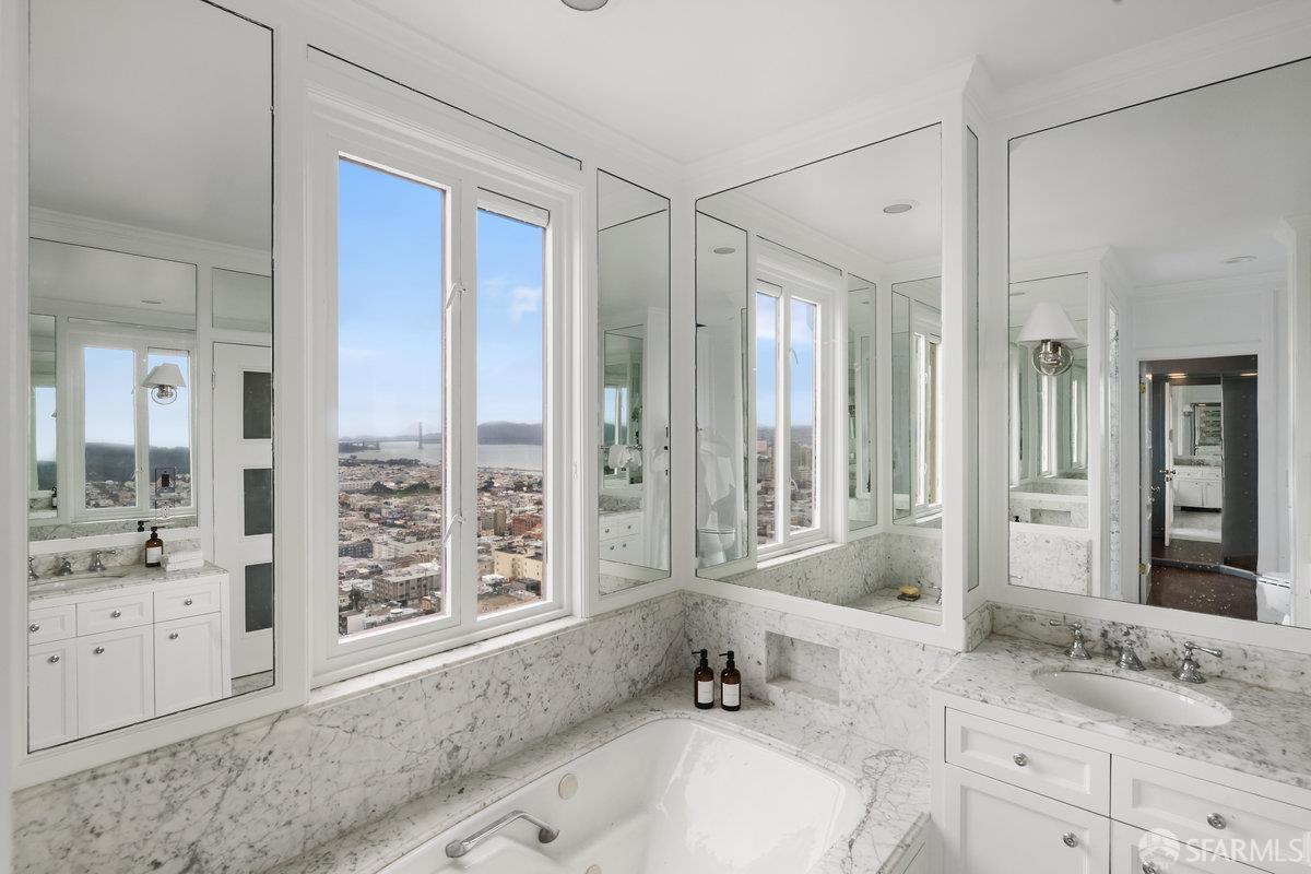 1101 Green Street, Unit 1801 San Francisco, CA 94109 - Photo 23 of 45 a bathroom with a granite countertop tub sink double vanity next to a window