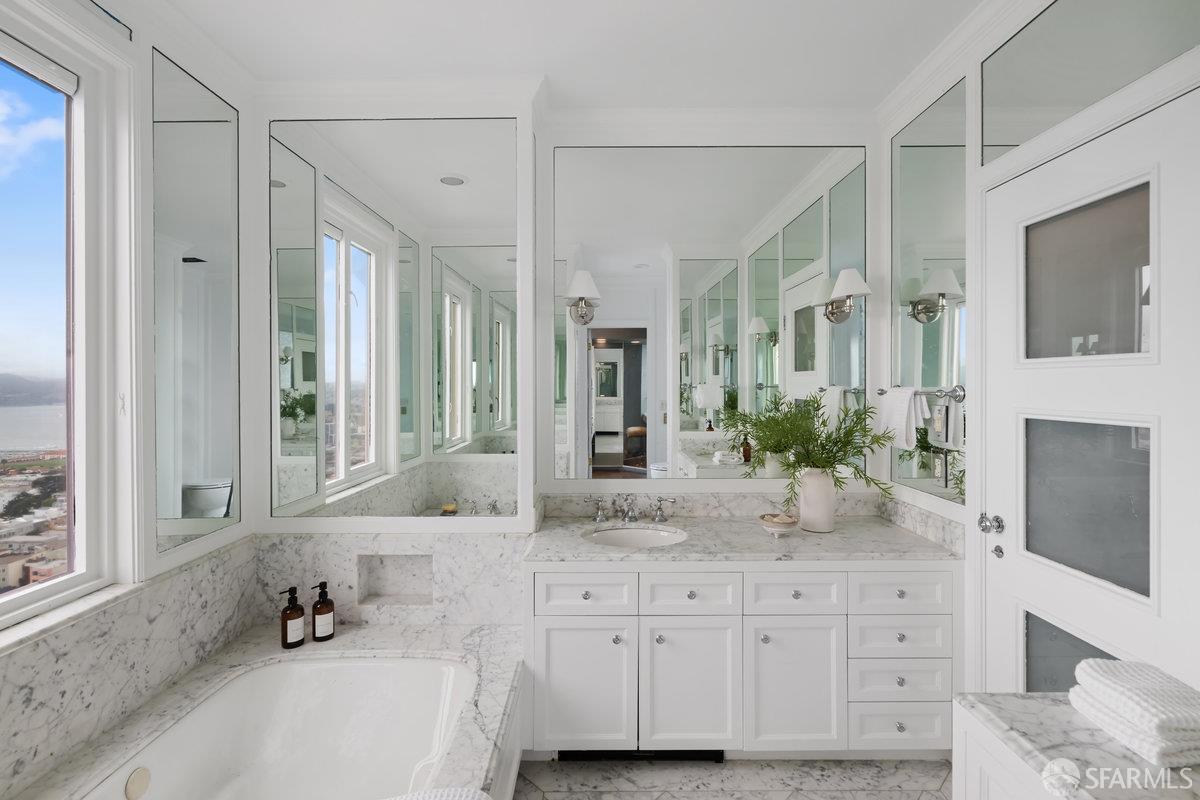 1101 Green Street, Unit 1801 San Francisco, CA 94109 - Photo 24 of 45 a bathroom with a granite countertop sink mirror and bathtub