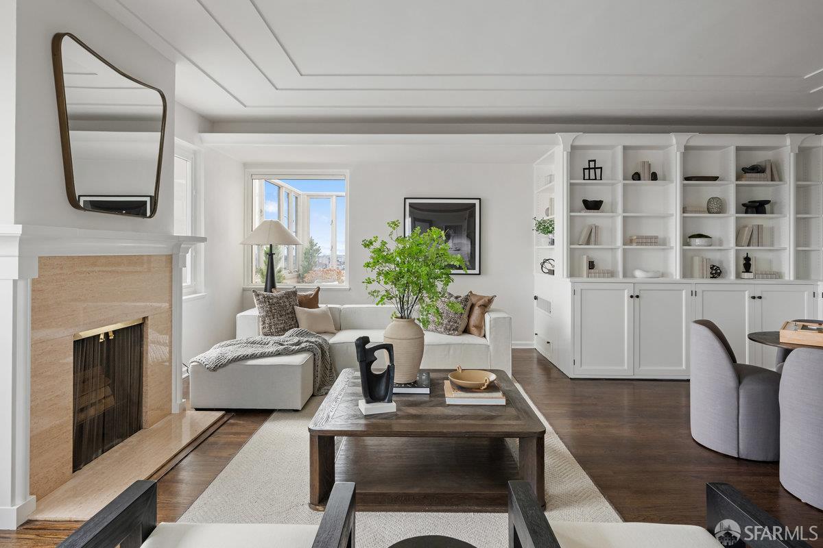 1101 Green Street, Unit 1801 San Francisco, CA 94109 - Photo 37 of 45 a living room with furniture a fireplace and a flat screen tv