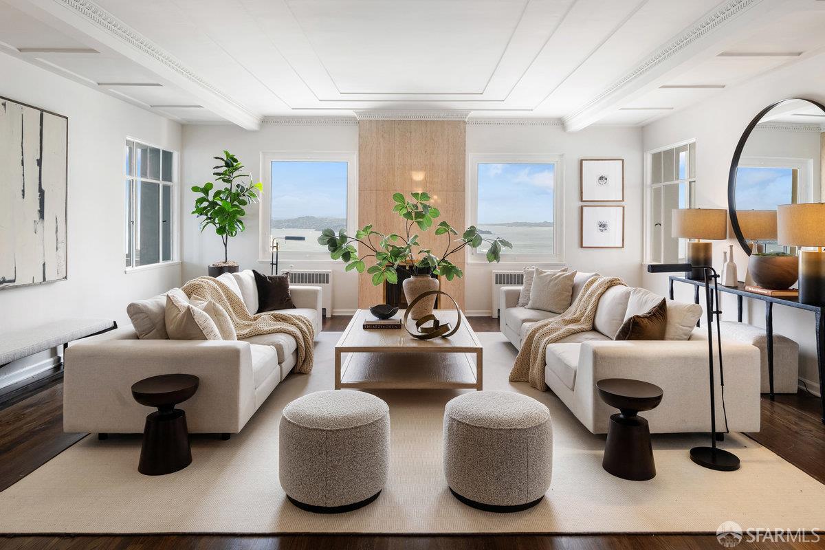 1101 Green Street, Unit 1801 San Francisco, CA 94109 - Photo 5 of 45 a living room with furniture a lamp wooden floor and a large window