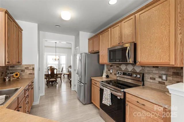 a kitchen with a stove a sink and a microwave