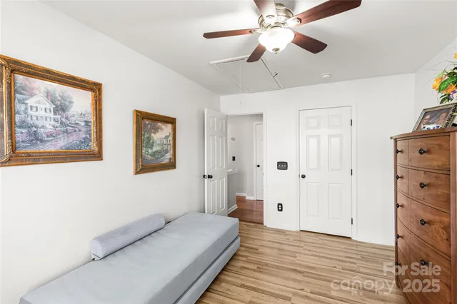 a spacious bedroom with a bed and a chandelier