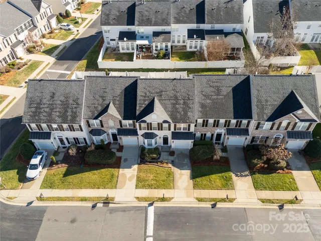 an aerial view of houses with outdoor space