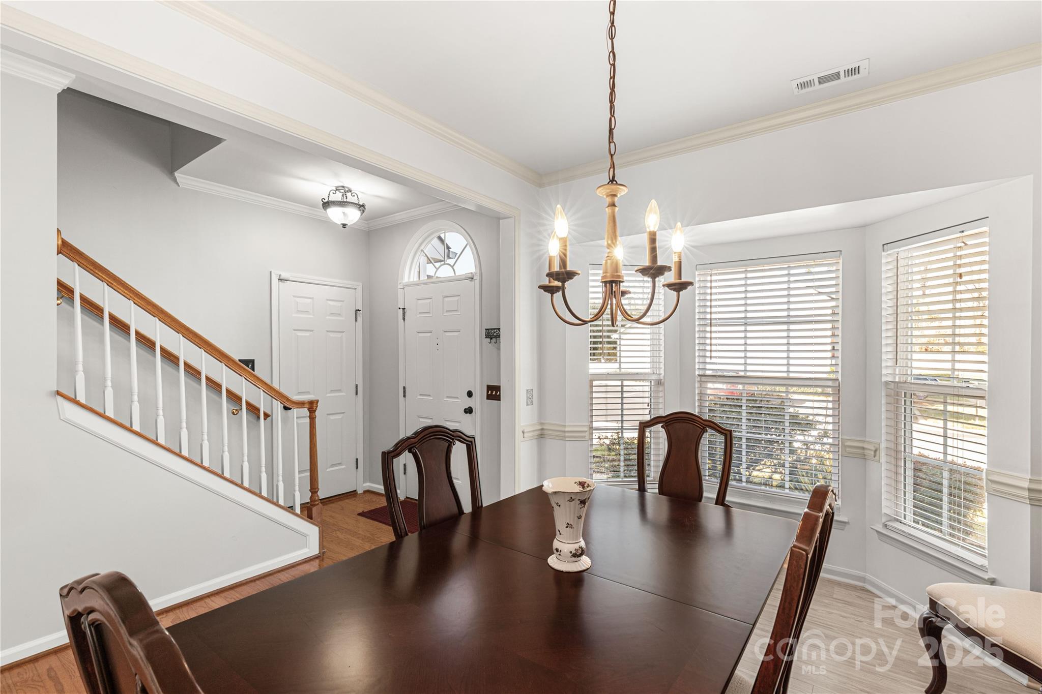 324 Dusk Drive Rock Hill, SC 29732 - Photo 7 of 39 a dining room with wooden floor a chandelier a glass table and chairs