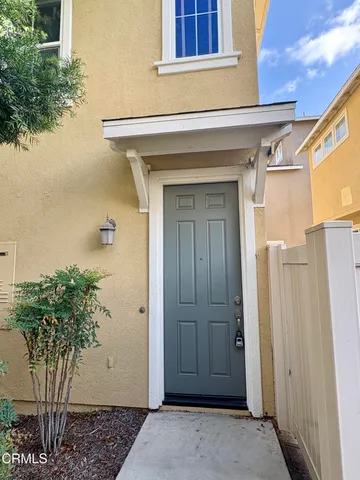 an open kitchen with kitchen island wooden floors and stainless steel appliances