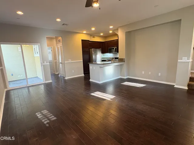 a kitchen with stainless steel appliances wooden cabinets and granite counter tops
