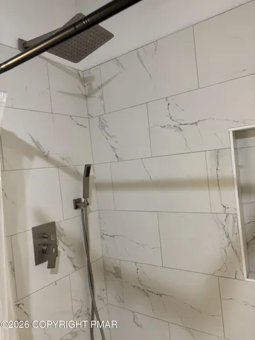 a bathroom with a toilet and a mirror