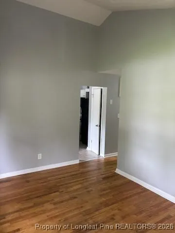 a view of a room with wooden floor