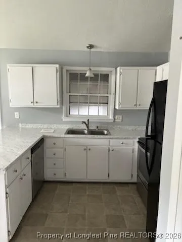a kitchen with a sink window and cabinets