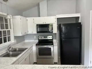 a kitchen with a sink and steel appliances