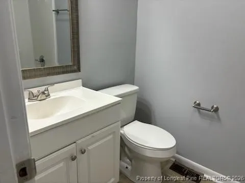 a white toilet sitting next to a bathroom sink