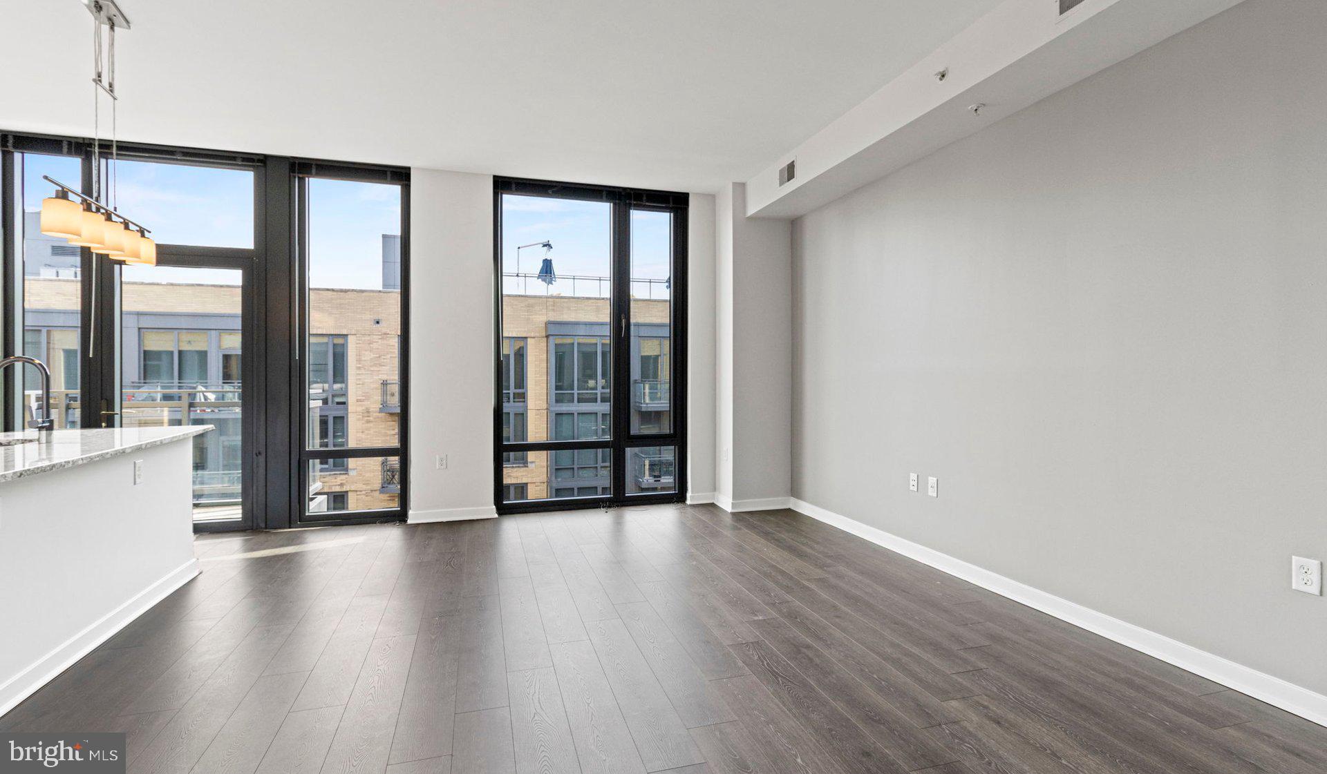 8300 Wisconsin Avenue, Unit 0B1313 Bethesda, MD 20814 - Photo 63 of 150 a view of an empty room with wooden floor and a window