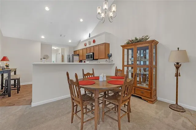 a view of a dining room with furniture and chandelier