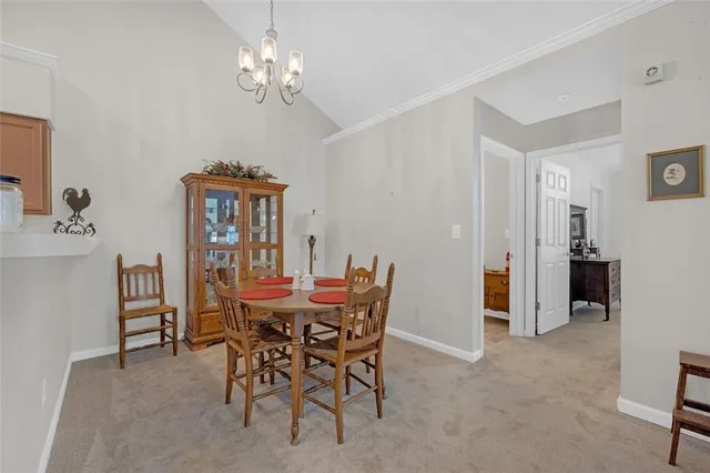 a view of a dining room with furniture and chandelier