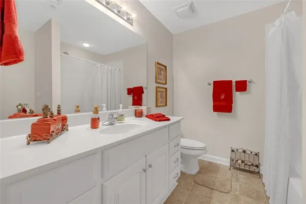 a bathroom with a sink mirror and toilet