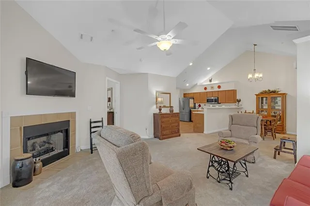 a living room with furniture a fireplace and a flat screen tv
