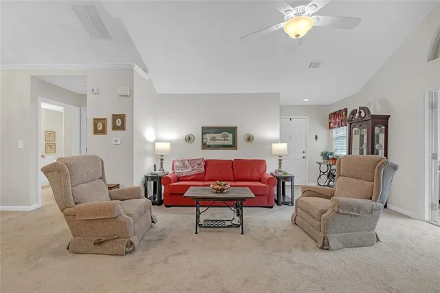 a living room with furniture and a lamp