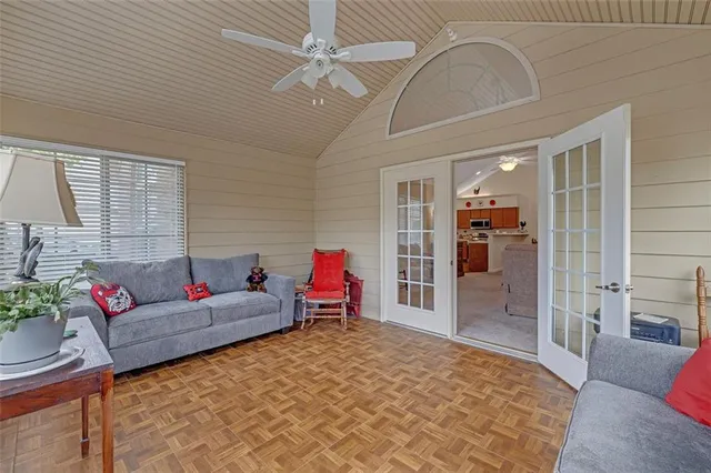 a living room with furniture and a chandelier