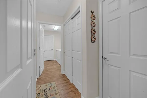 a view of a hallway with wooden floor