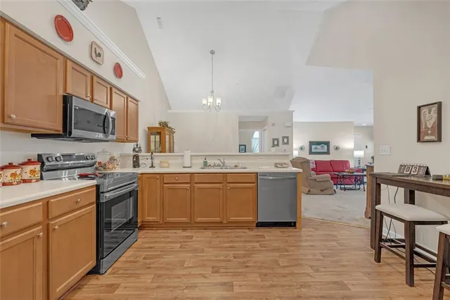 a kitchen with a sink cabinets and wooden floor