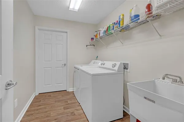 a utility room with cabinets washer and dryer