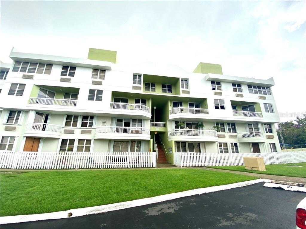 a front view of a building with a garden