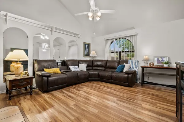 a living room with furniture a fireplace and a chandelier