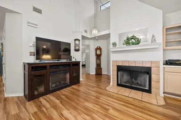 a living room with a fireplace a flat screen tv and a fireplace