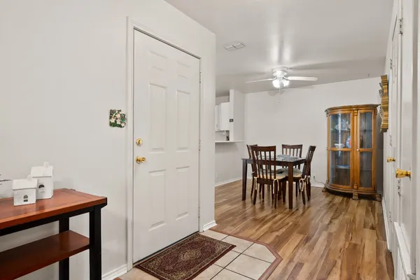 a dining room with furniture and wooden floor