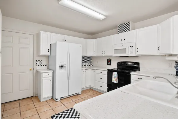 a kitchen with stainless steel appliances a refrigerator sink and cabinets
