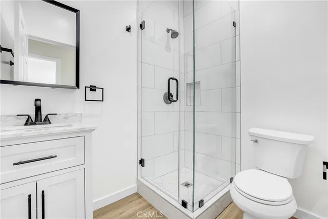 a bathroom with a shower a toilet and sink