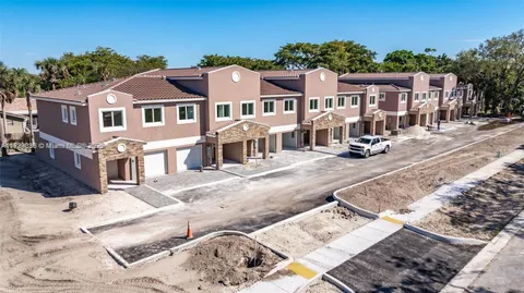 an aerial view of multiple houses with yard