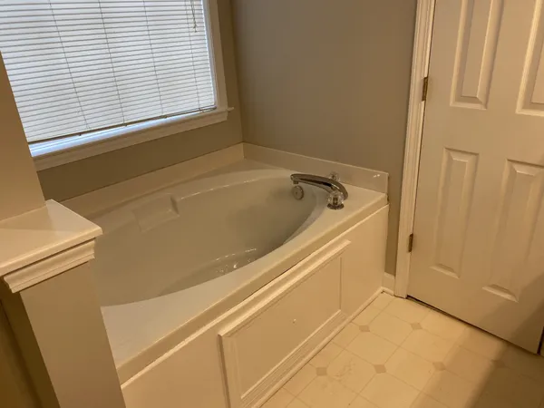 a view of an empty room with wooden floor and closet