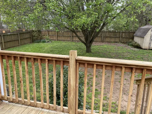 a view of backyard with deck and wooden floor