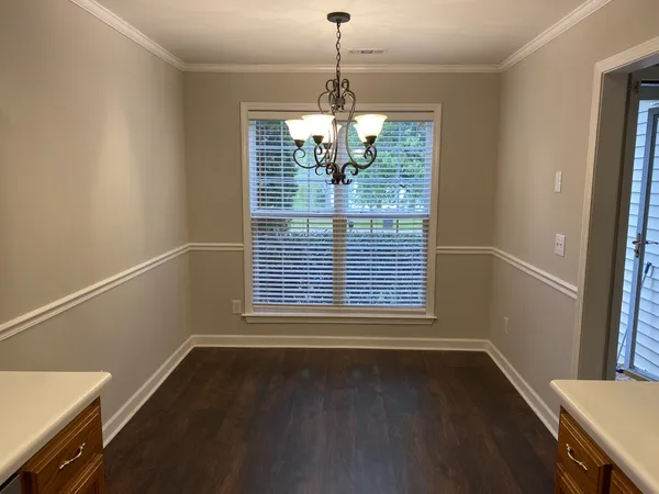 a view of a room with wooden floor and windows
