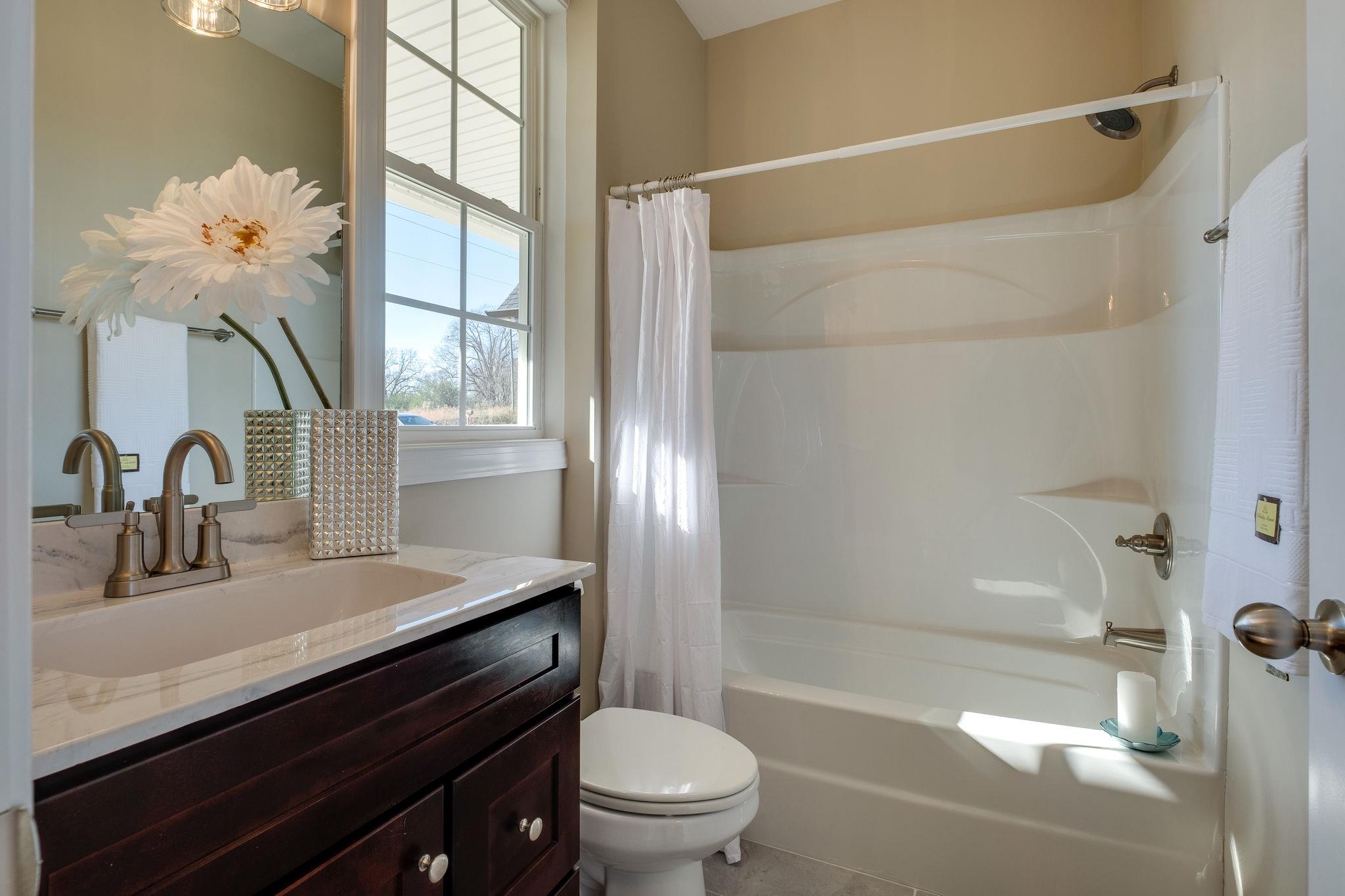 1809 Abiff Road Burns, TN 37029 - Photo 24 of 28 a bathroom with a sink a toilet and a bathtub