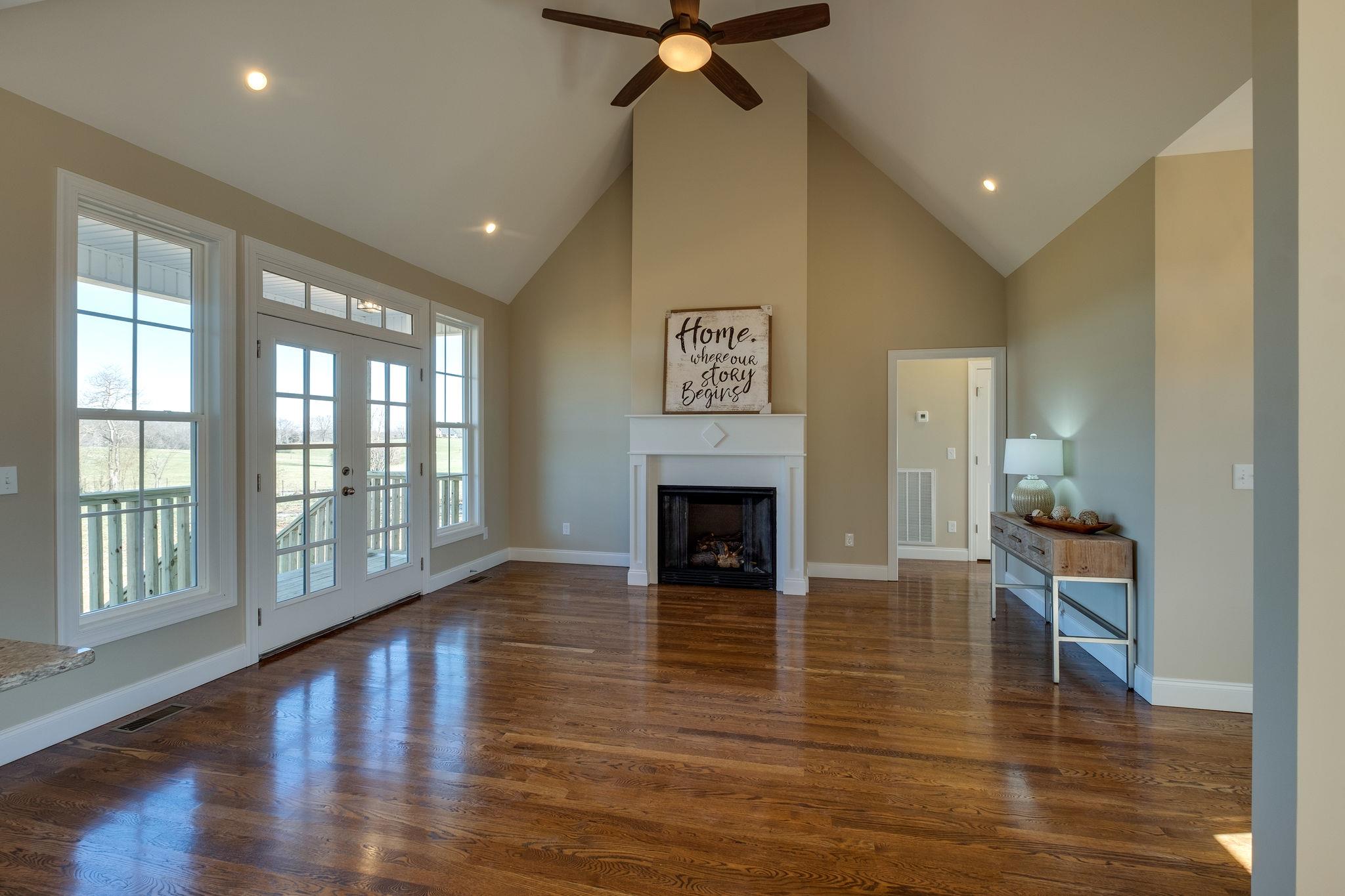 1809 Abiff Road Burns, TN 37029 - Photo 4 of 28 a view of an empty room with wooden floor and a window
