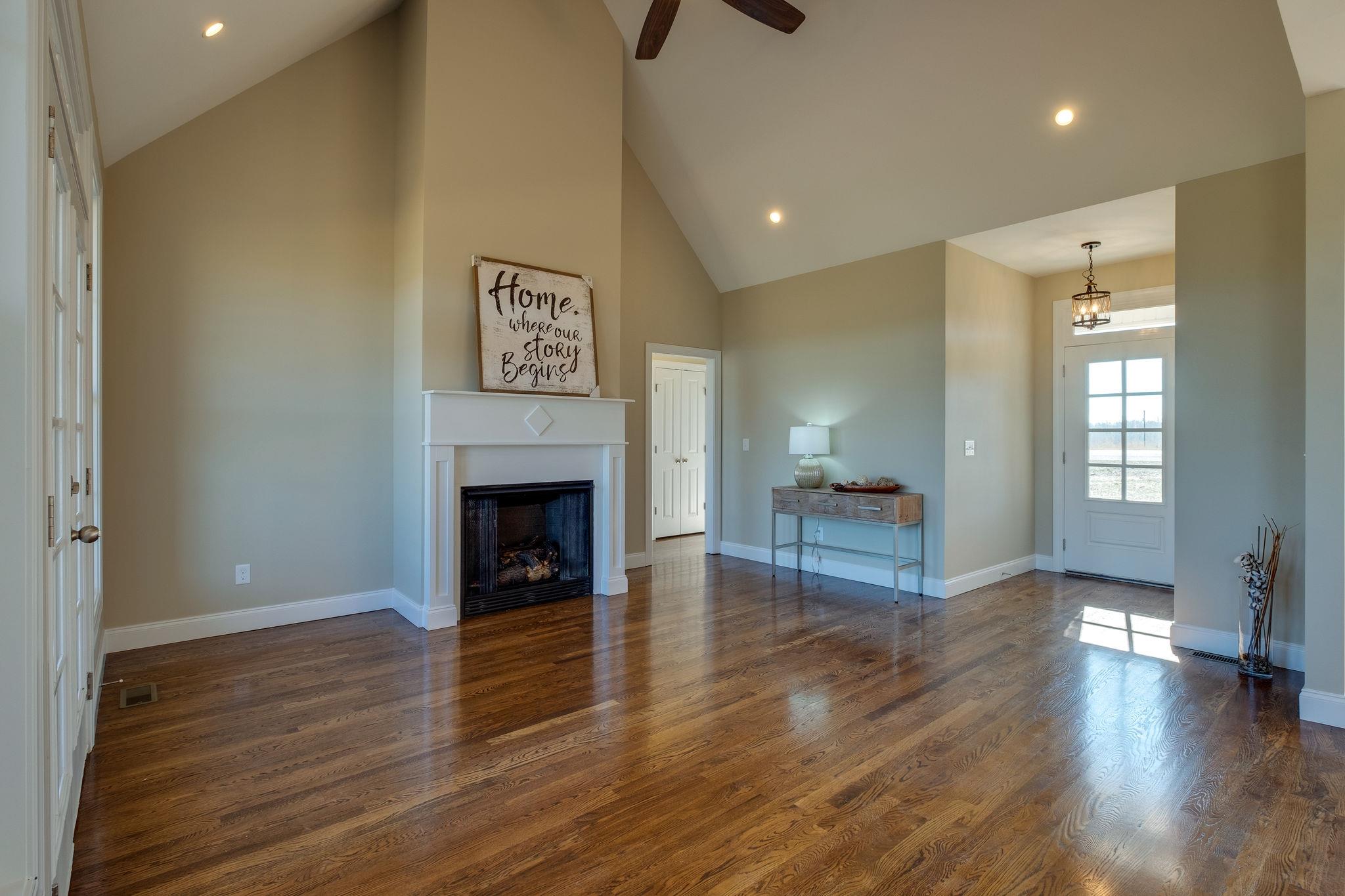 1809 Abiff Road Burns, TN 37029 - Photo 6 of 28 a view of a livingroom with wooden floor and a fireplace