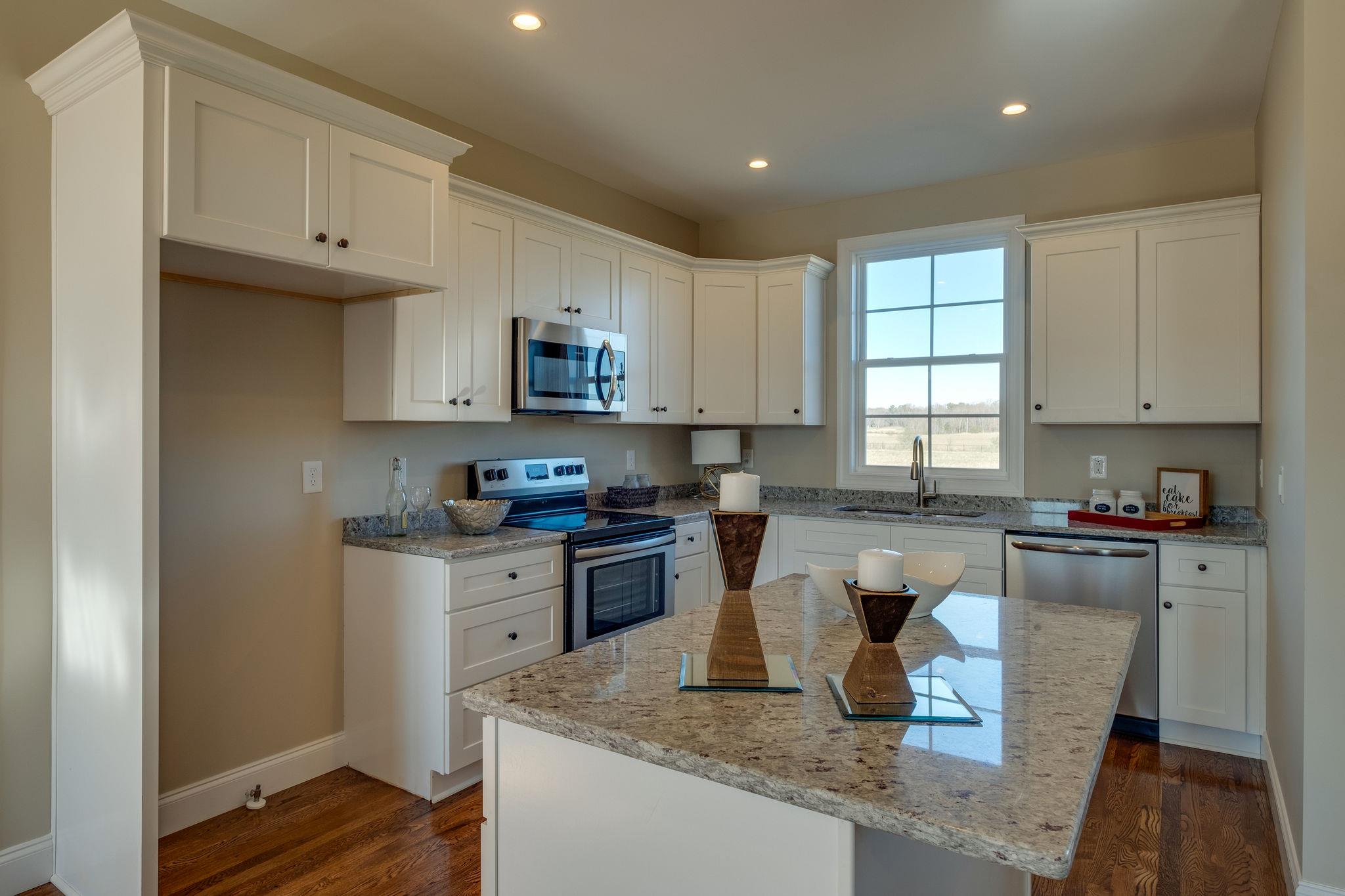1809 Abiff Road Burns, TN 37029 - Photo 7 of 28 a kitchen with a sink a stove a microwave and cabinets
