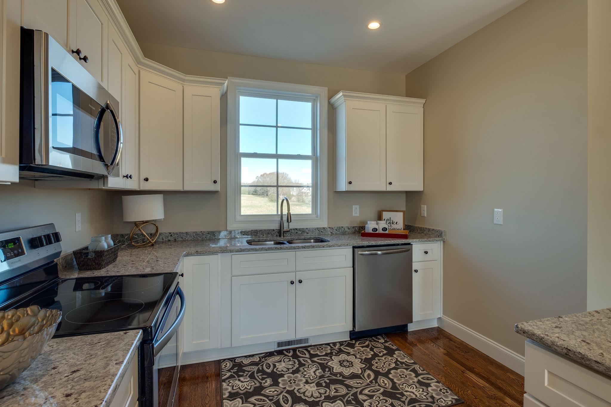 1809 Abiff Road Burns, TN 37029 - Photo 9 of 28 a kitchen with stainless steel appliances granite countertop a stove and cabinets