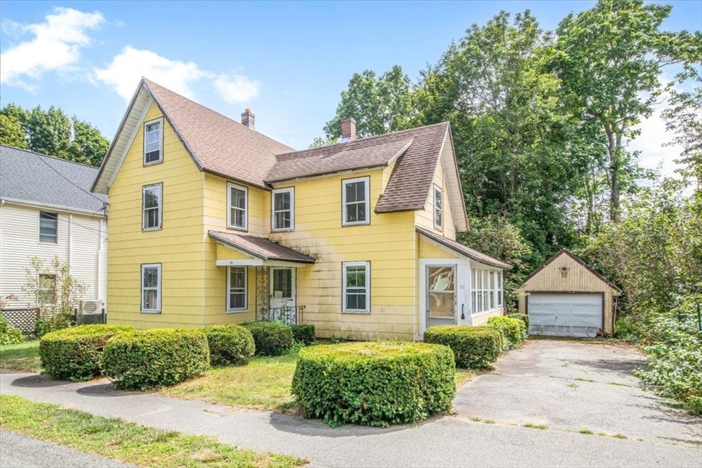 50 Clark Street Dedham, MA 02026 - Photo 1 of 38 a front view of a house with a yard and garage