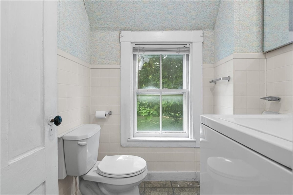 50 Clark Street Dedham, MA 02026 - Photo 11 of 38 a white toilet sitting next to a bathroom sink