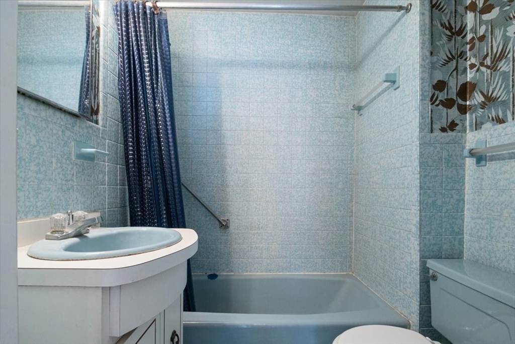 50 Clark Street Dedham, MA 02026 - Photo 19 of 38 a bathroom with a sink a toilet and shower