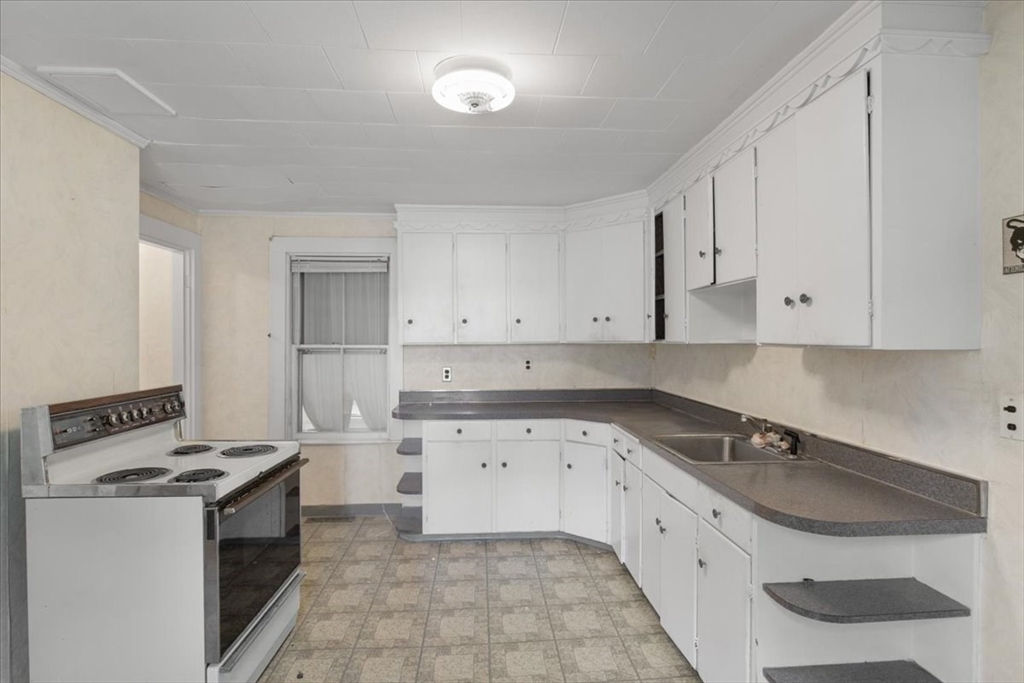 50 Clark Street Dedham, MA 02026 - Photo 2 of 38 a kitchen with granite countertop a sink a stove and cabinets