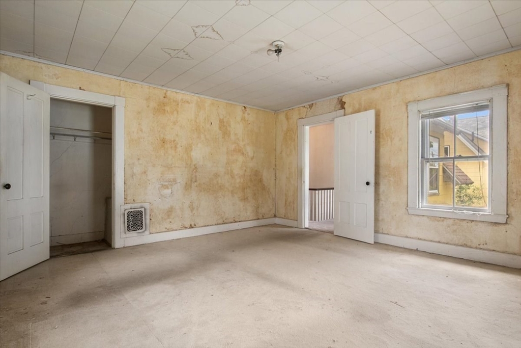 50 Clark Street Dedham, MA 02026 - Photo 26 of 38 a view of an empty room with a window